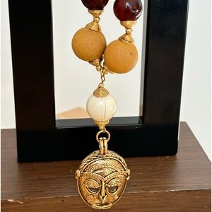 Tribal mask pendant necklace/ gold tone/ mustard, cranberry & white colors